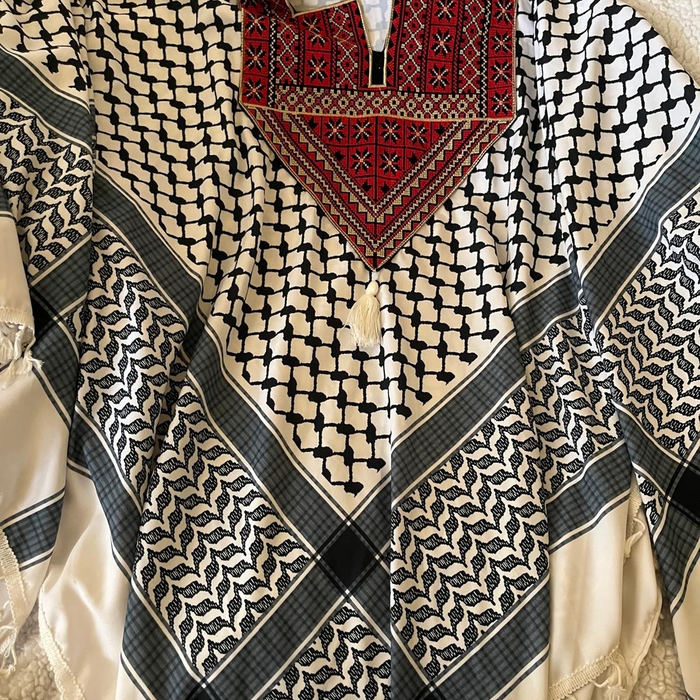 Traditional Black and White Patterned Garment with Red Embroidery